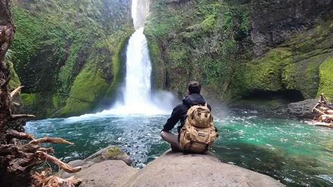 Man Sitting in front of Waterfall Stock Footage 294120166