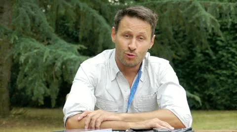 Man sitting in garden talking to camera Video stock 14831855