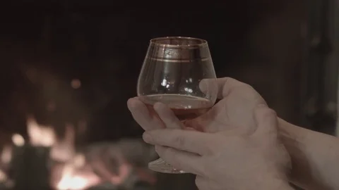 The man is sitting with a glass 스톡 동영상 74196669
