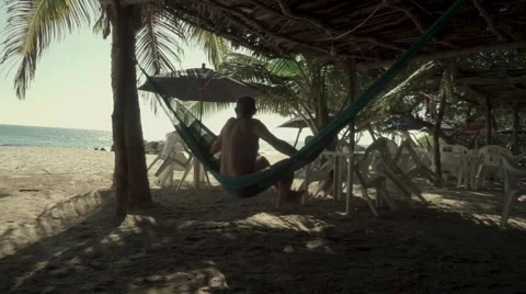 Man sitting on hammock Stock Footage 45993973