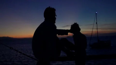 Man sitting with his son and enjoying their time, steadycam shot, slow motion sh Stock-Footage 83243550