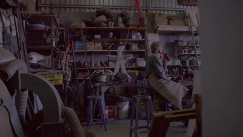 Man sitting in his workshop and drinking a beer Stock Footage 278992846