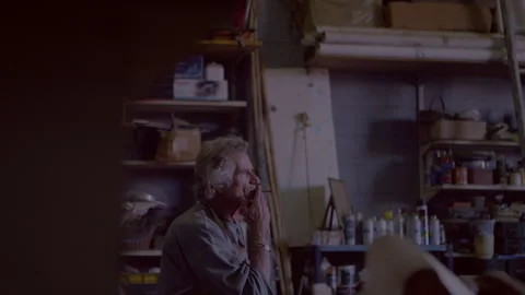 Man sitting in his workshop and smoking Stock Footage 278993402