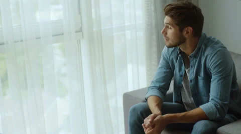 Man sitting at home and smiling on camera Stock Footage 68723924