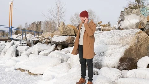 Man sitting on the ice and talking on the phone Stock-Footage 101317199