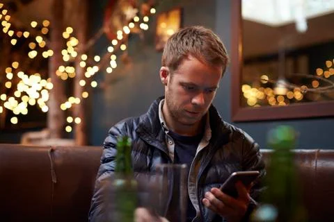 Man Sitting Inside Cafe Sending Text Message Stock Photos