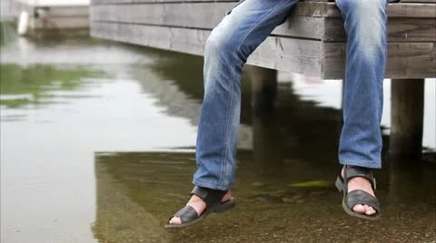 A man sitting on a jetty Stock Footage 11312016