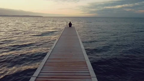 Man sitting on jetty Stock Footage 163314010