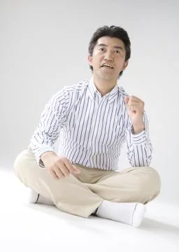 Man sitting with legs crossed Stock Photos
