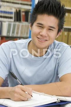 Man sitting in library studying Stock Photos