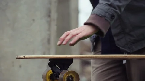 Man sitting on longboard and checking smartwatch. 스톡 동영상 90536822