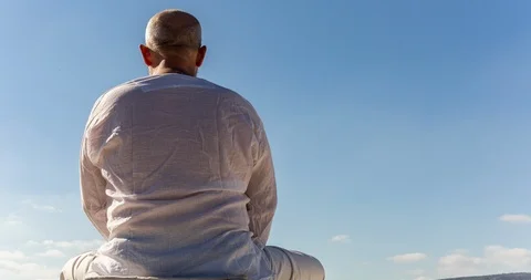 Man sitting in Meditation from behind Time Lapse Stock Footage 112305875