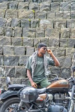 A man is sitting on a motorcycle Stock Photos