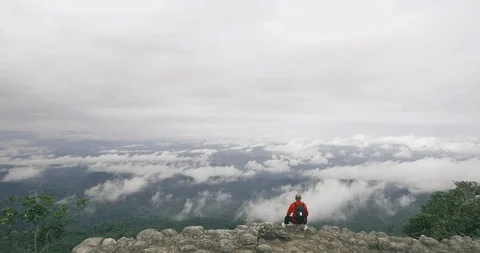 Man sitting on mountain top Stock Footage 89689313