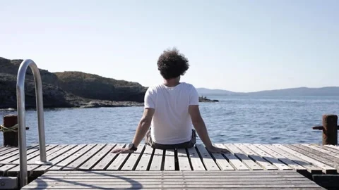 Man sitting near the dock Stock Footage 143938488