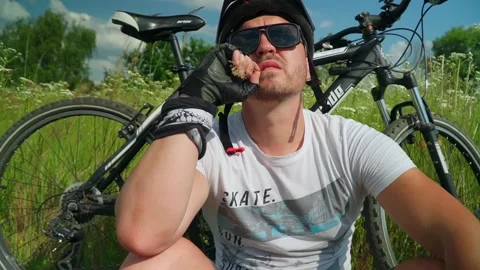 A man sitting next to his bike Stock Footage 156041653