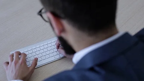 Man Sitting In Office And Typing On Laptop Stock Footage 76327296
