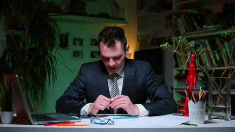 A man sitting at an office desk makes a business idea over implementation. 動画素材 137227984