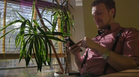 The man sitting in the office using a smartphone Stock Footage 49339809