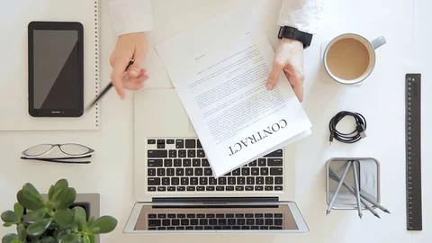 Man sitting in office working on project on laptop, sign contract Stock Footage 79602790