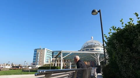 Man sitting outside San Raffaele hospital, Milan, Italy Vídeo Stock 242289488