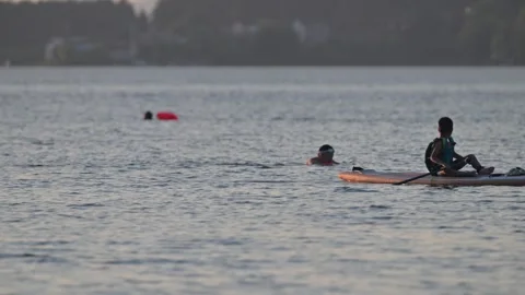Man Sitting on Paddleboard in Lake Stock-Footage 345039005