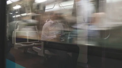 Man Sitting in Paris Metro Reflection with Trains Passing by Stock Footage 115847065