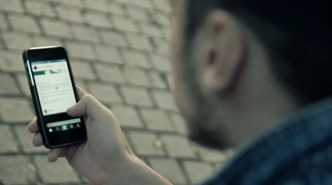 Man sitting in the park and looking at the phone. Instagram Stock Footage 51741415
