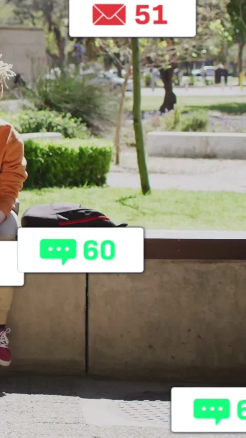 Man sitting on park bench tapping phone to check texts, causing social badges Stock Footage 330189648