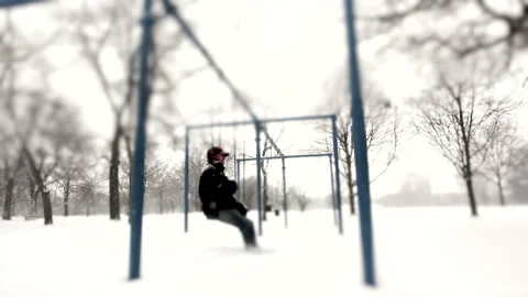Man Sitting in a Park During a Blizzard  Stock Footage 162257010