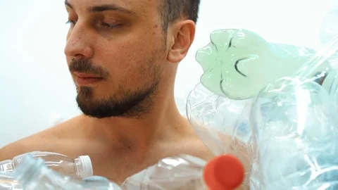 Man sitting in a pile of plastic Stock Footage 125329419