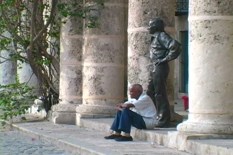 Man sitting in plaza Stock Footage 397182