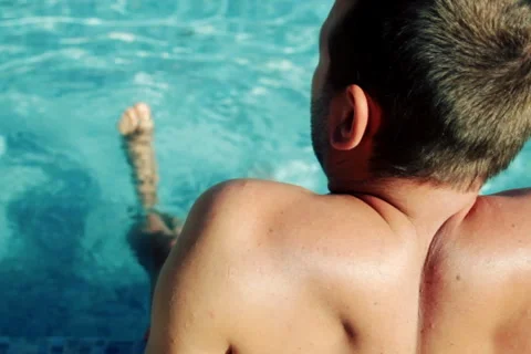 Man sitting by the pool Stock Footage 1092975