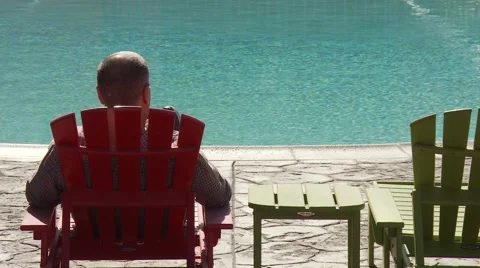 Man sitting poolside. Stock Footage 64220812