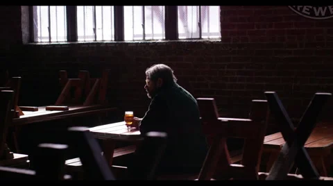 Man sitting in a restaurant and having beer 動画素材 61504478