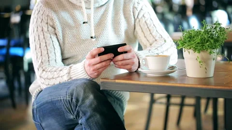 Man sitting in the restaurant and texting on smartphone Stock-Footage 48127440