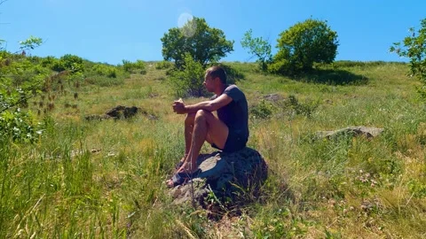 Man sitting on a rock Video stock 196804268