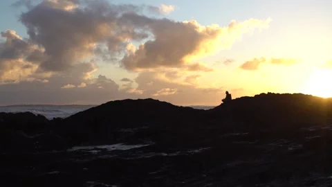 Man Sitting On Rock At Sunet Stock Footage 158991672