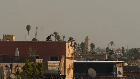 Man sitting on rooftop. Marrakech, Morocco. Video stock 103857290