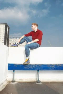 Man sitting on rooftop wall 写真素材