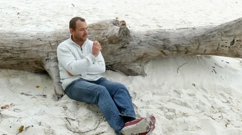 A man sitting in the sand Stock Footage 55072982