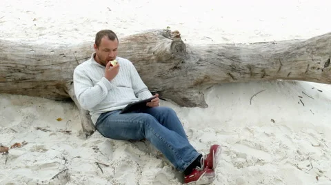 A man sitting in the sand Video stock 55074652