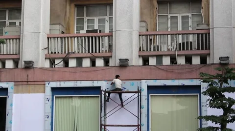 Man sitting on scaffolding Stock Footage 58626053