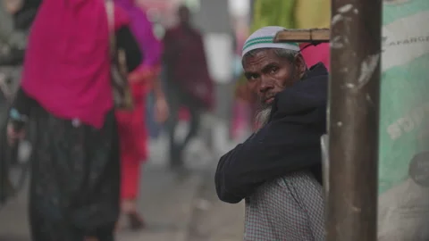Man Sitting on the Side of the road in Dhaka, Bangladesh Stock Footage 142028058