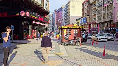A man sitting on the sidewalk with a dog Video stock 272863114
