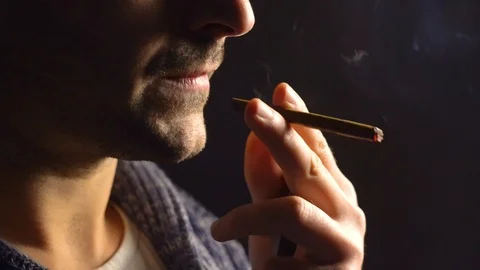 Man sitting, smoking cigarette Video stock 100679424