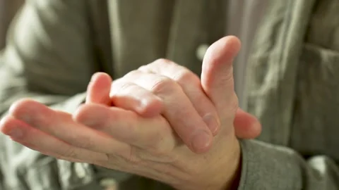 Man Sitting on Sofa and Massaging his Hand Stock Footage 270729725