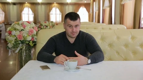 Man sitting on sofa and talking during a serious, emotional interview Stock Footage 72952043