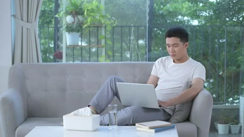 Man Sitting Sofa And Use Laptop Computer In Living Room Stock Footage 156169858