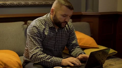 Man sitting on sofa and working  Stock Footage 60662875